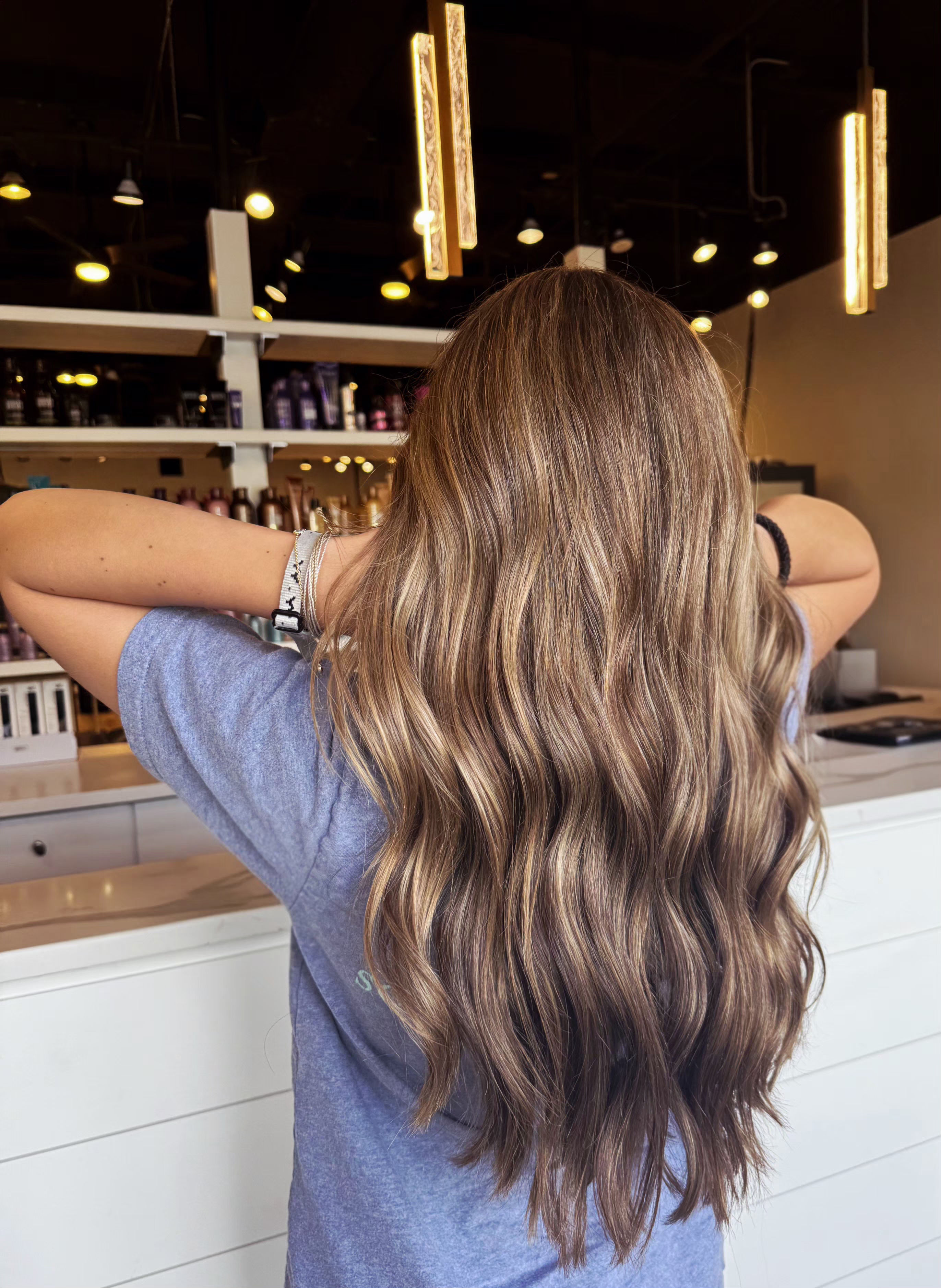 Lived-in brunette color with soft face-framing highlights — hair by Lili Barker in Leander, TX
